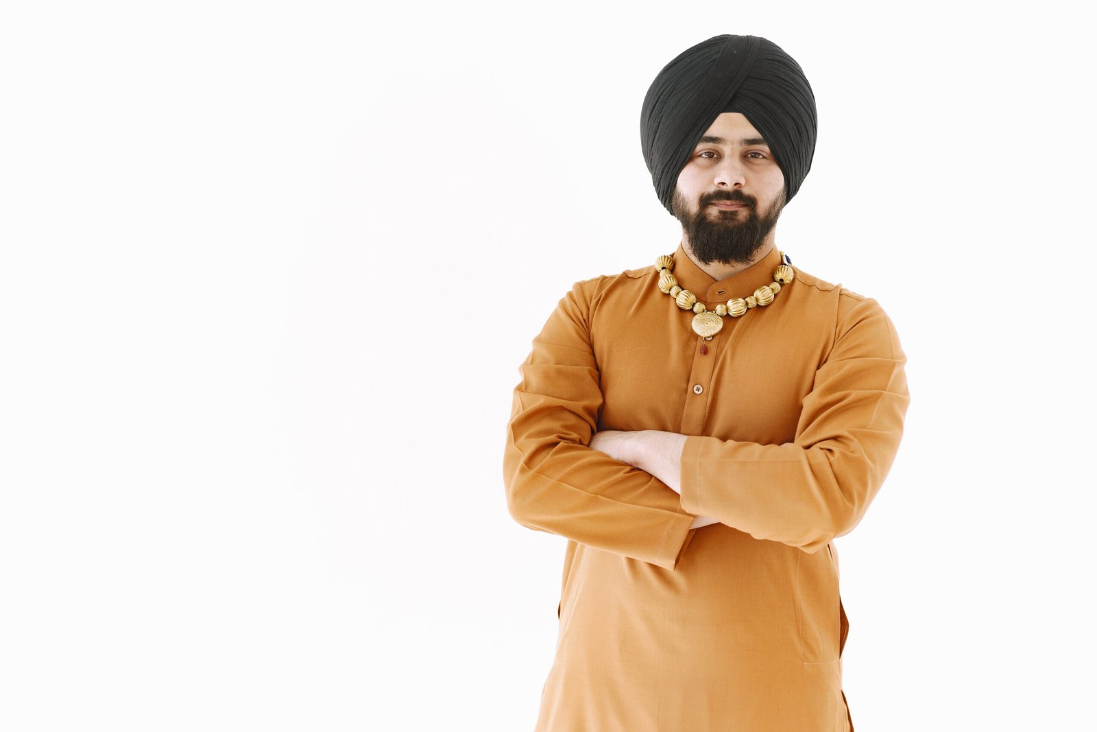young man posing casually white wall scaled